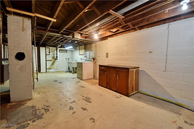 basement with separate washer and dryer and sink