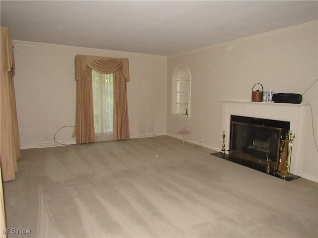 unfurnished living room featuring ornamental molding and carpet flooring