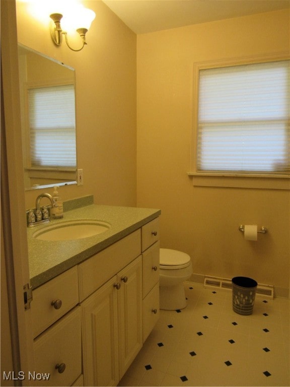 bathroom with tile patterned flooring, vanity, and toilet