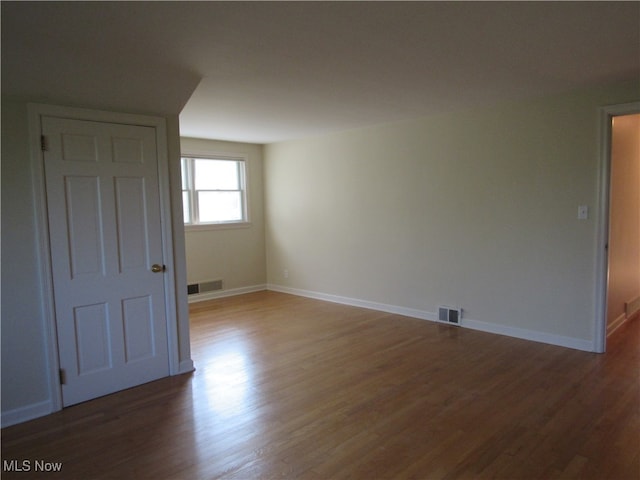 spare room with dark wood-type flooring