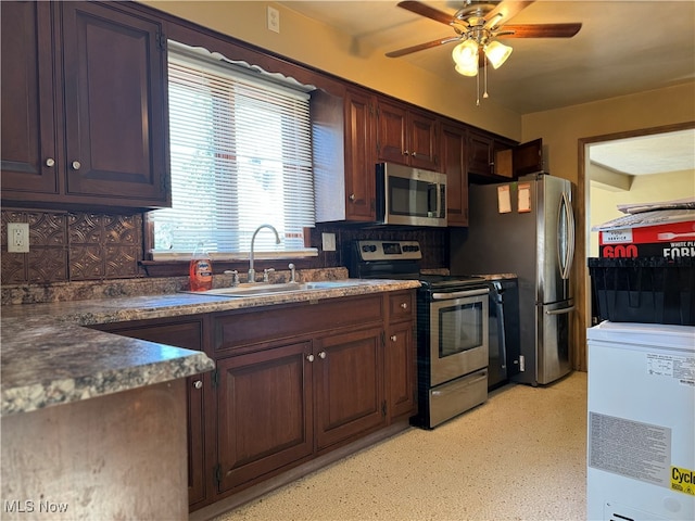 kitchen featuring tasteful backsplash, stainless steel appliances, sink, ceiling fan, and dark brown cabinetry