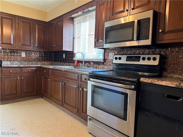 kitchen featuring appliances with stainless steel finishes, tasteful backsplash, and sink