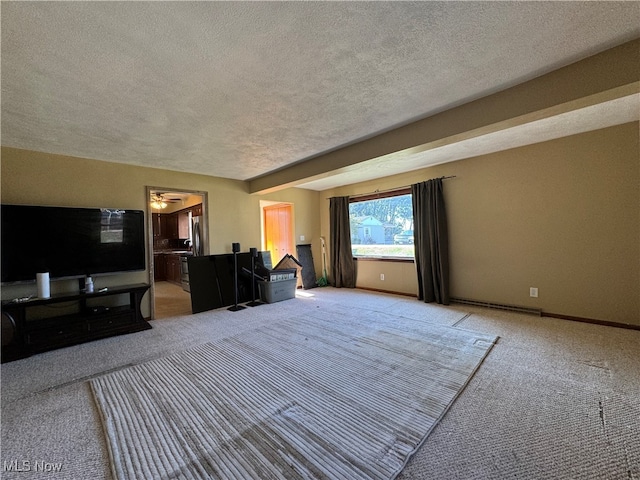 unfurnished living room featuring ceiling fan, carpet, and a textured ceiling