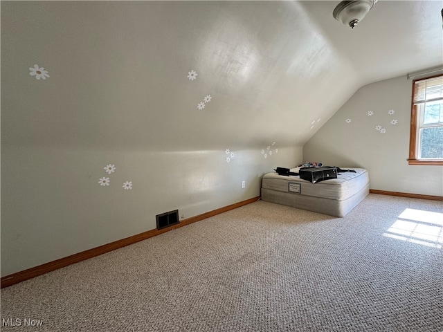 bonus room featuring vaulted ceiling and light carpet