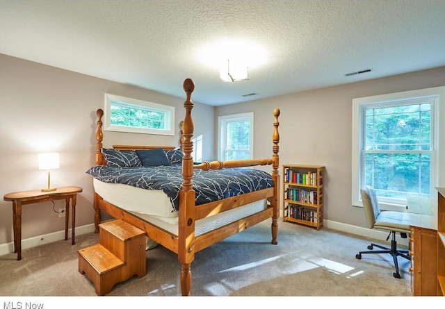 carpeted bedroom featuring a textured ceiling