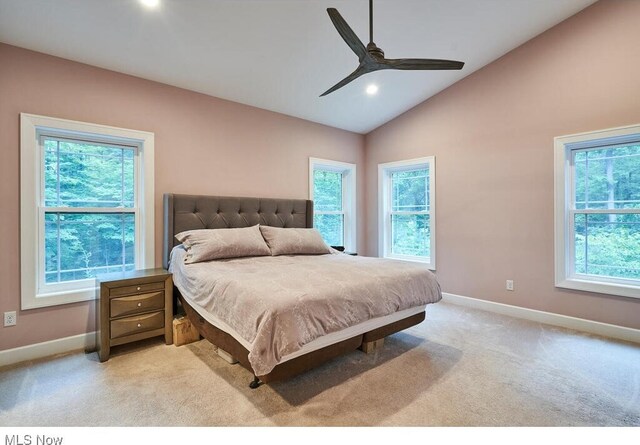 bedroom with lofted ceiling, multiple windows, and ceiling fan