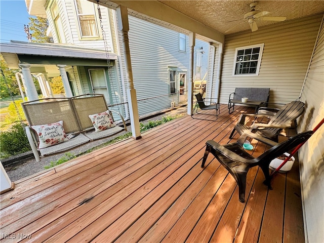 wooden terrace featuring ceiling fan