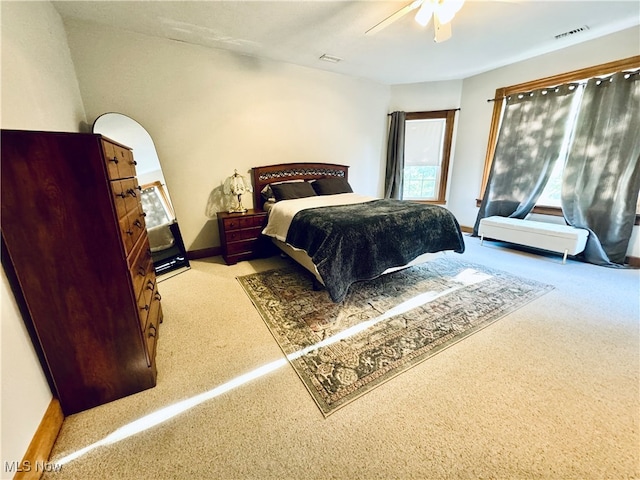 bedroom featuring light carpet and ceiling fan