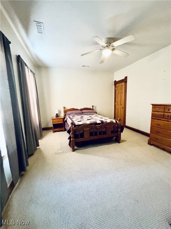 carpeted bedroom with ceiling fan