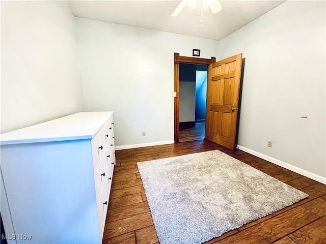 interior space featuring ceiling fan and dark wood-type flooring