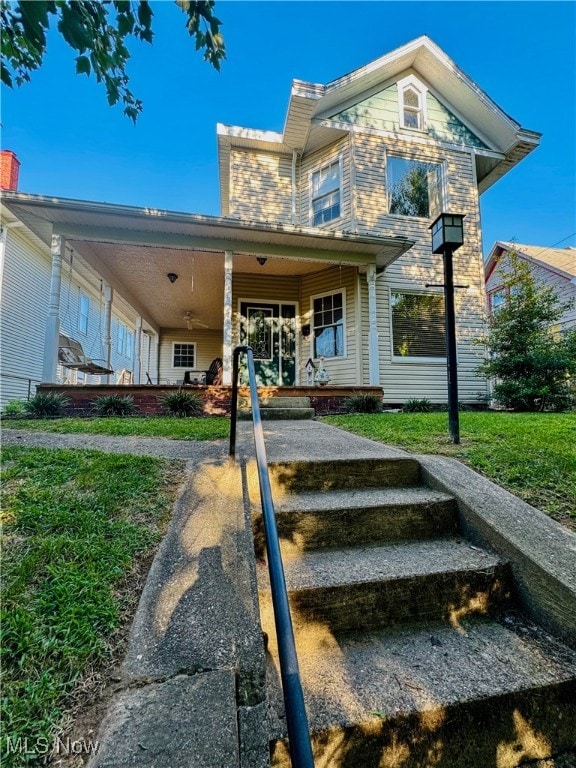 view of front of property with a porch and a front lawn