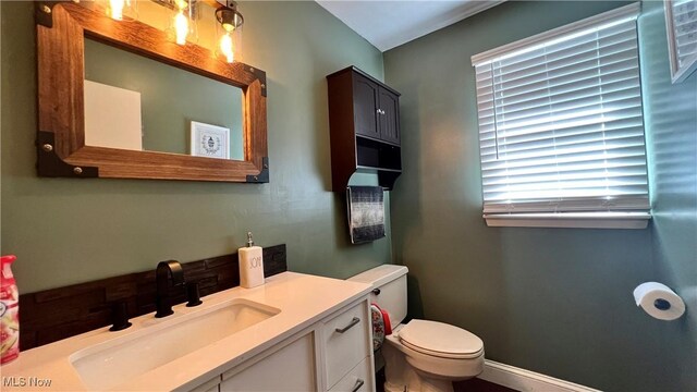 bathroom with toilet and vanity