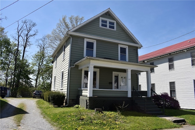 view of front of house with covered porch and a front yard