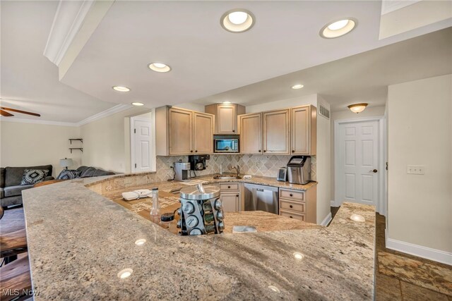 kitchen featuring kitchen peninsula, appliances with stainless steel finishes, light brown cabinetry, light stone countertops, and crown molding