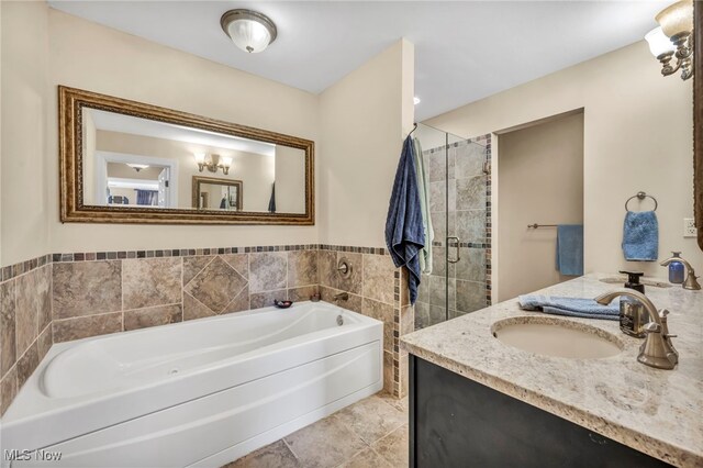 bathroom with shower with separate bathtub, tile patterned floors, and vanity