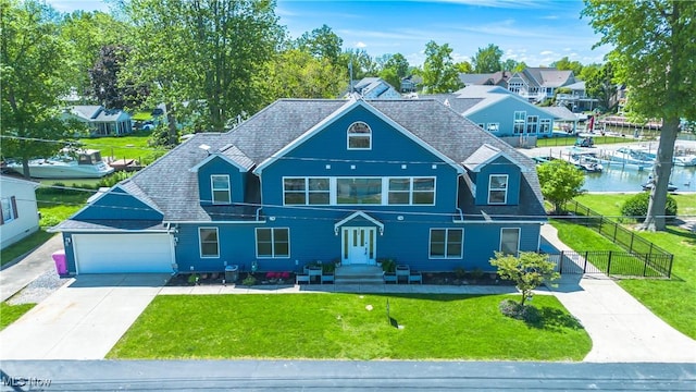 1909 N Nan Ave, Lakeside-Marblehead, OH 43440 - view of front of house with concrete driveway, a garage, a water view, and roof with shingles