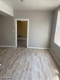 empty room with light hardwood / wood-style floors