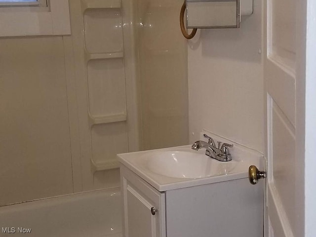 bathroom with walk in shower and vanity