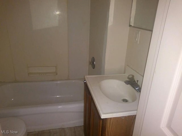 full bathroom with vanity, toilet, and shower / washtub combination