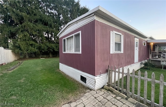 view of side of home with a lawn