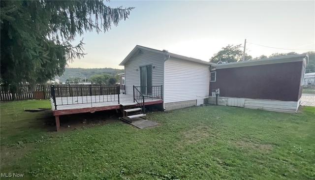 exterior space featuring a lawn and a wooden deck