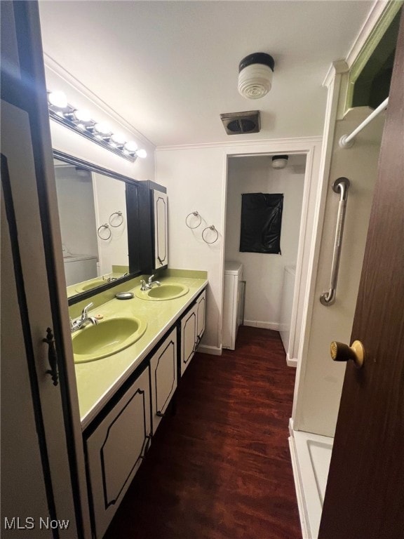 bathroom with crown molding, vanity, hardwood / wood-style floors, and walk in shower