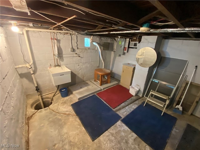 basement featuring sink and electric panel