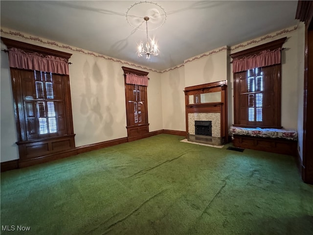 unfurnished living room with an inviting chandelier and carpet flooring