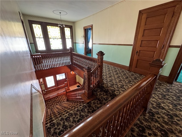 stairway with a chandelier