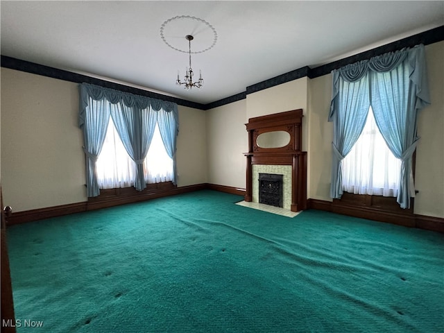 unfurnished living room featuring a notable chandelier and carpet flooring