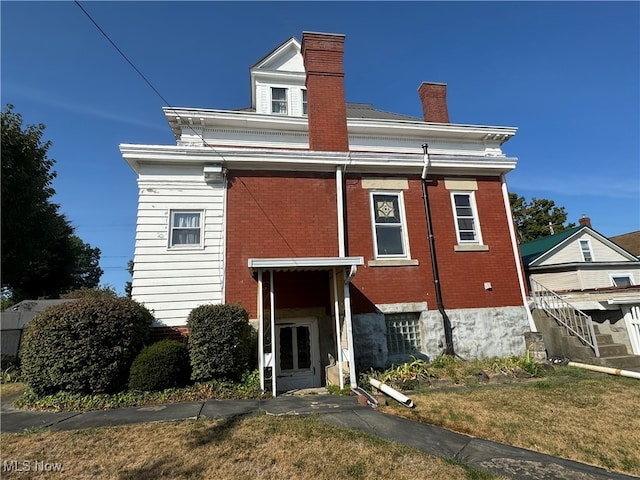 rear view of property featuring a yard