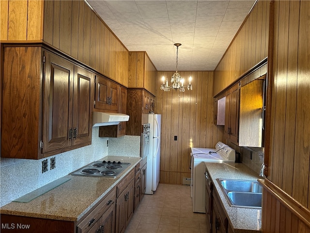 kitchen with decorative backsplash, separate washer and dryer, stainless steel gas cooktop, light tile patterned floors, and sink