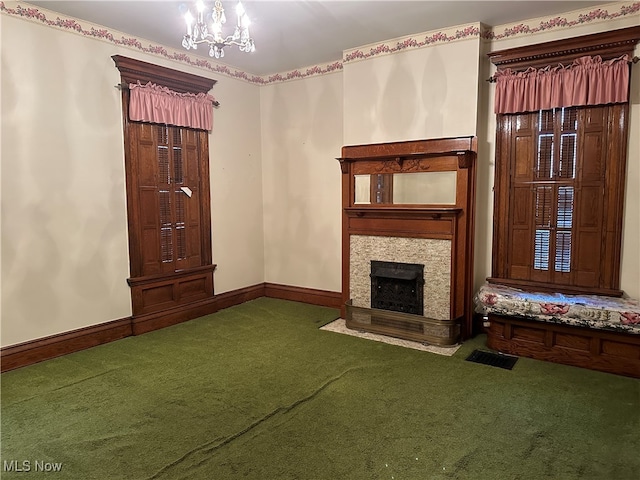 unfurnished living room featuring an inviting chandelier, carpet floors, and a fireplace