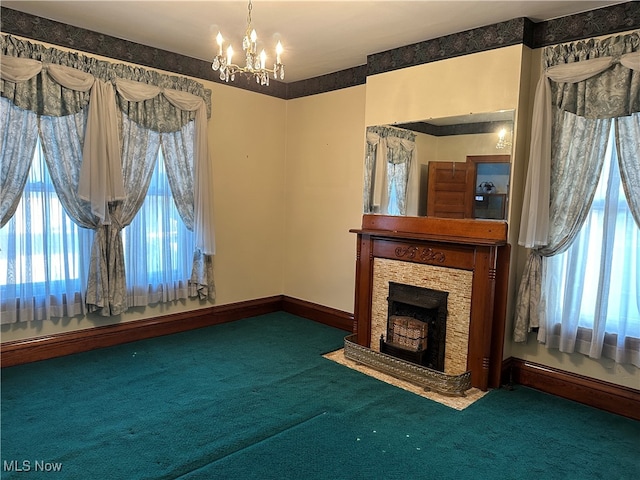 unfurnished living room featuring carpet flooring and a chandelier