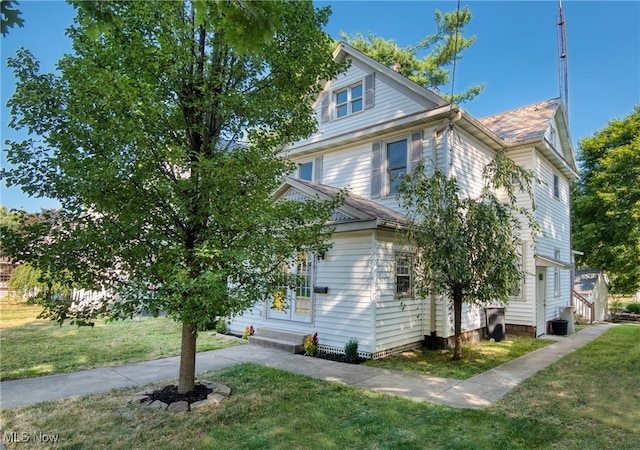 view of side of home featuring a yard and cooling unit