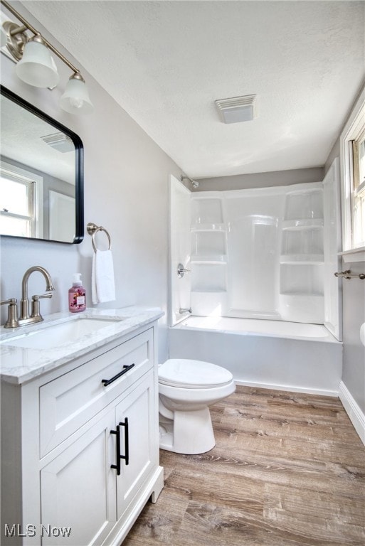 full bathroom with vanity, toilet, shower / bathtub combination, and hardwood / wood-style flooring