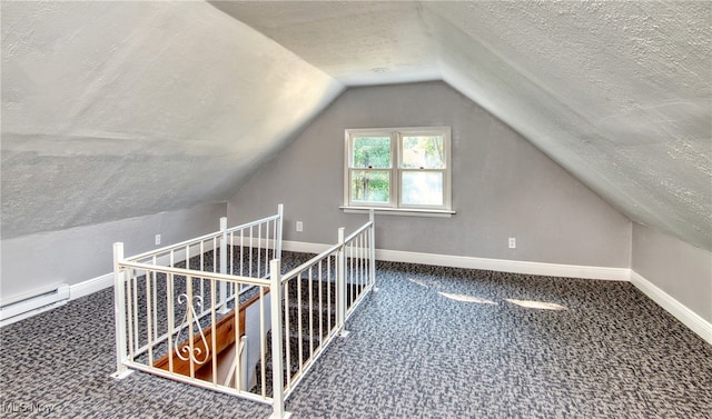 additional living space with a textured ceiling, carpet flooring, and lofted ceiling