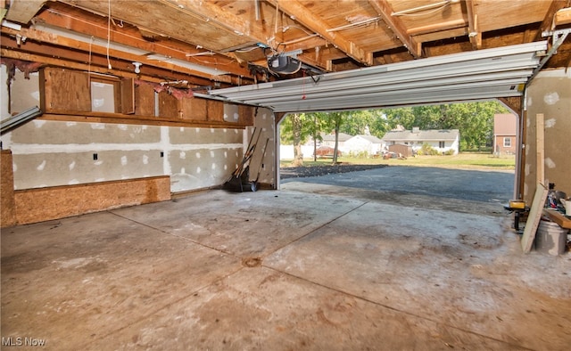 garage featuring a garage door opener and a carport