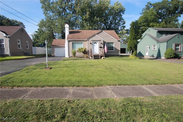 view of front of home with a garage and a front lawn