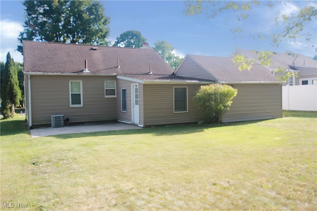 back of property featuring a patio, a lawn, and central air condition unit