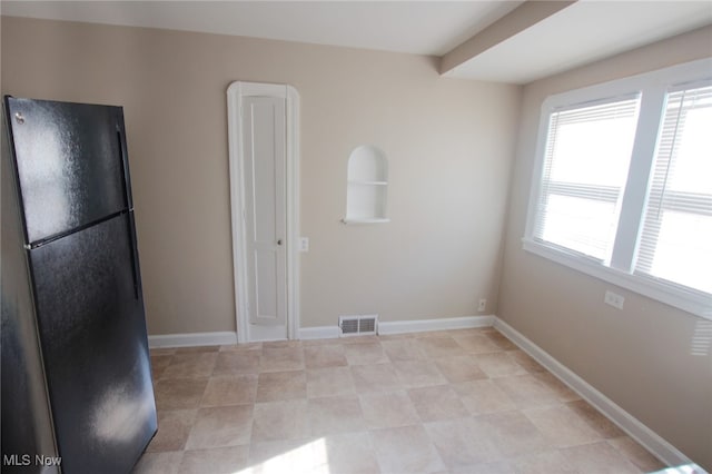 kitchen featuring black refrigerator