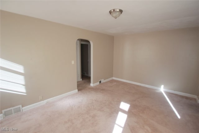 unfurnished room with light carpet