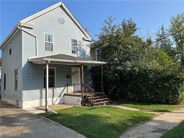 view of front property with covered porch and a front yard