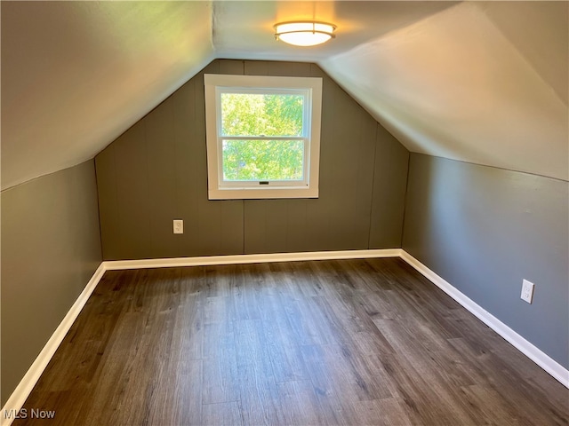 bonus room featuring lofted ceiling and dark hardwood / wood-style floors