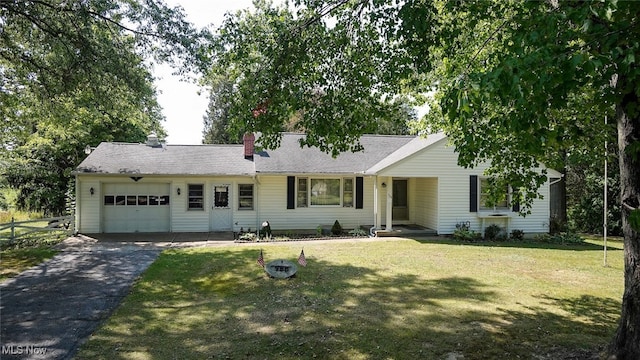 single story home featuring a garage and a front lawn