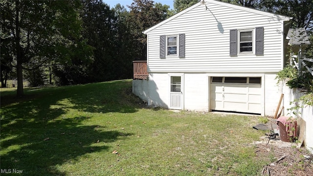 view of home's exterior featuring a garage and a lawn