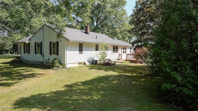 view of side of home featuring a lawn