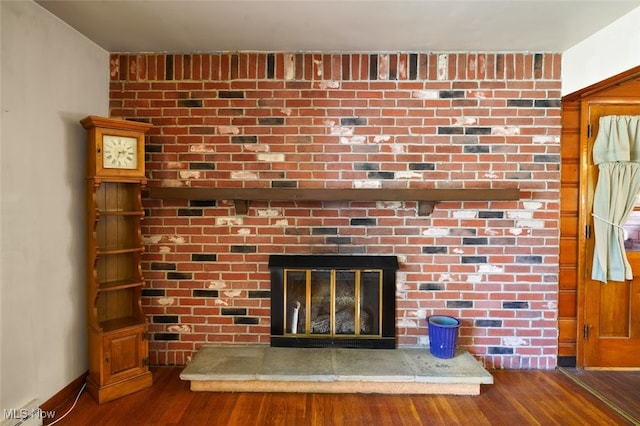 room details with hardwood / wood-style floors and a fireplace