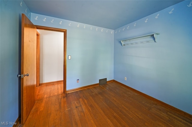 spare room featuring wood-type flooring