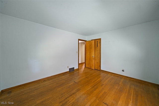 empty room with wood-type flooring